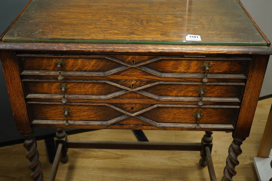 A 1920’s canteen of Old English pattern flatware, housed in a Queen Anne style oak cabinet, 87cm high